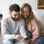 smiley-couple-suing-smartphone-home
